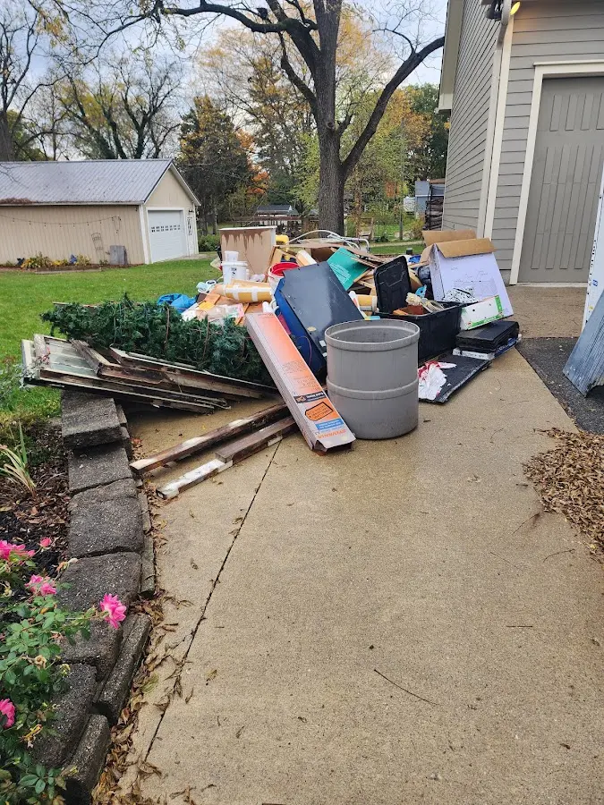 Dumpster being loaded with debris for Estate Cleanout Dumpster Rental in Doffing